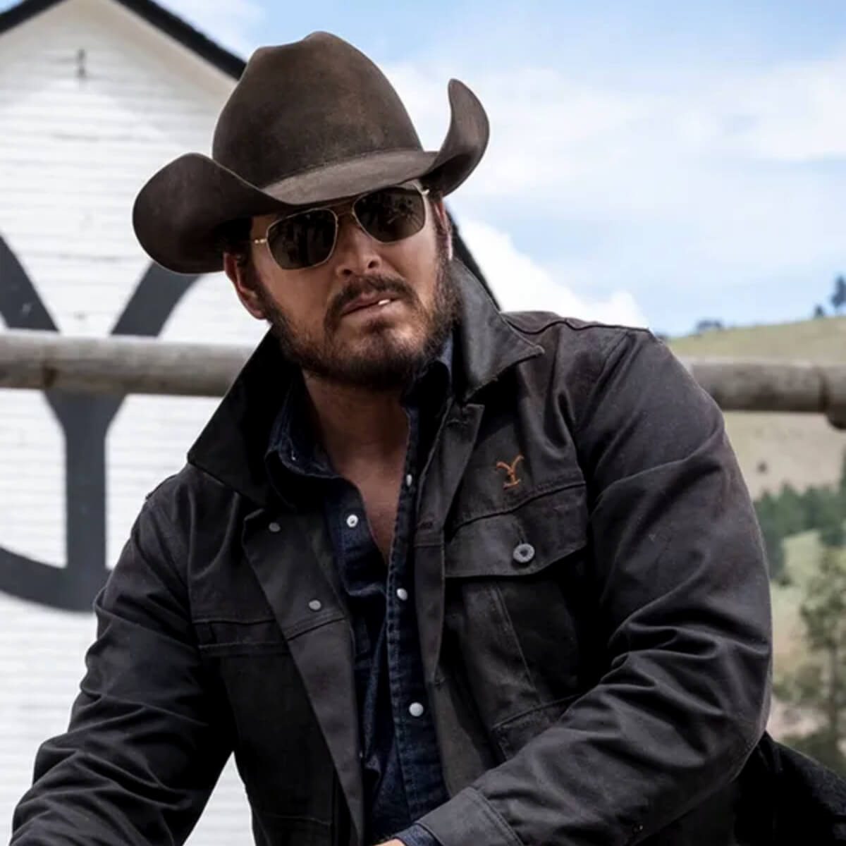Rip Wheeler wearing a cowboy hat and dark jacket outdoors