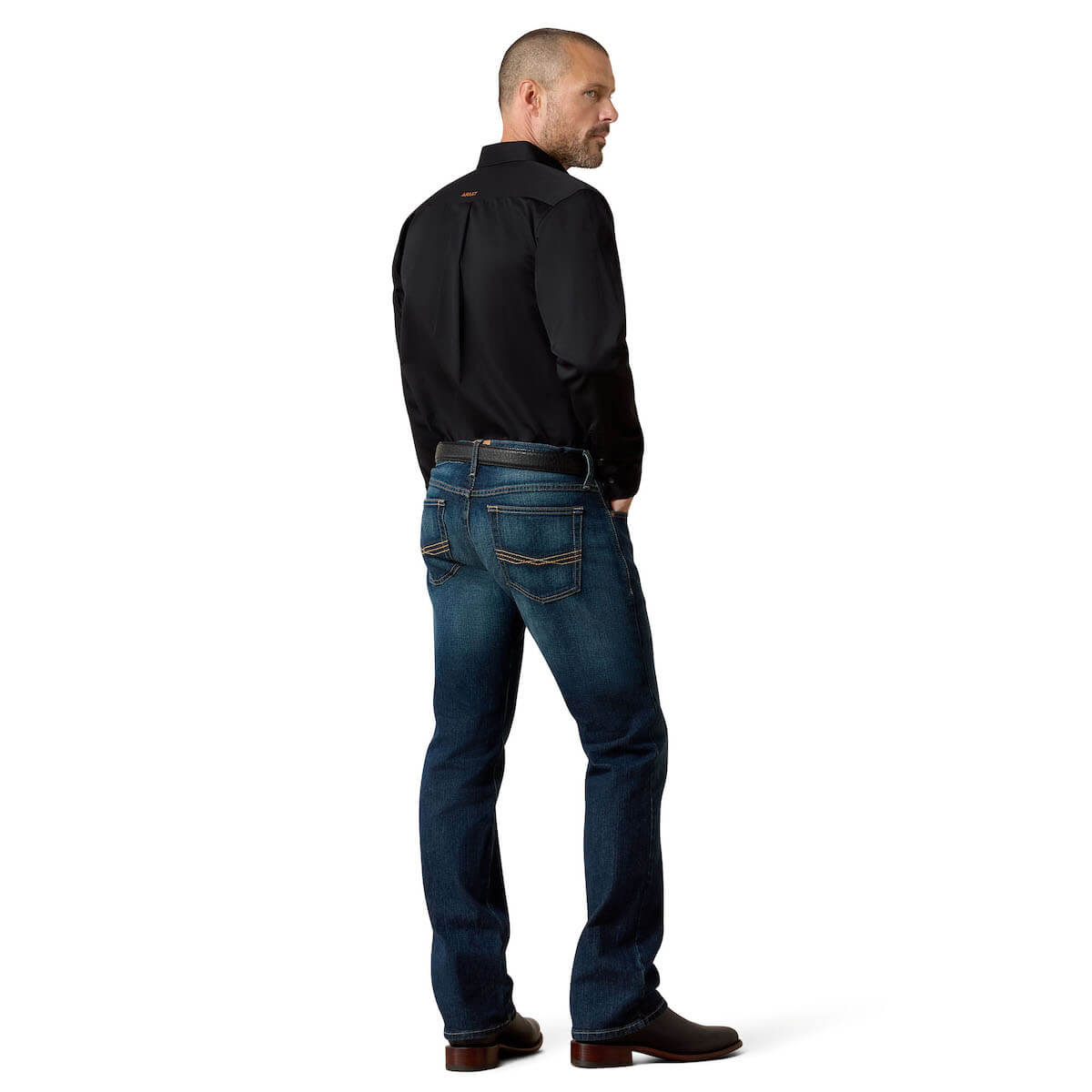 Man wearing a black shirt and blue jeans on a white background
