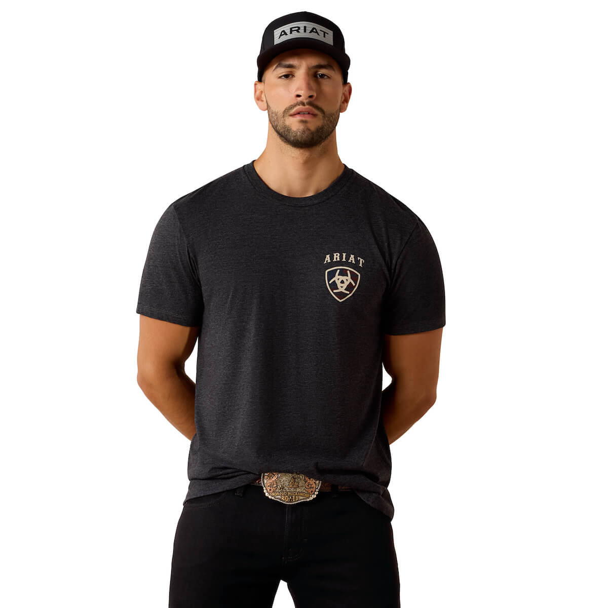 Man wearing a black t-shirt with Ariat logo and a cap on a white background