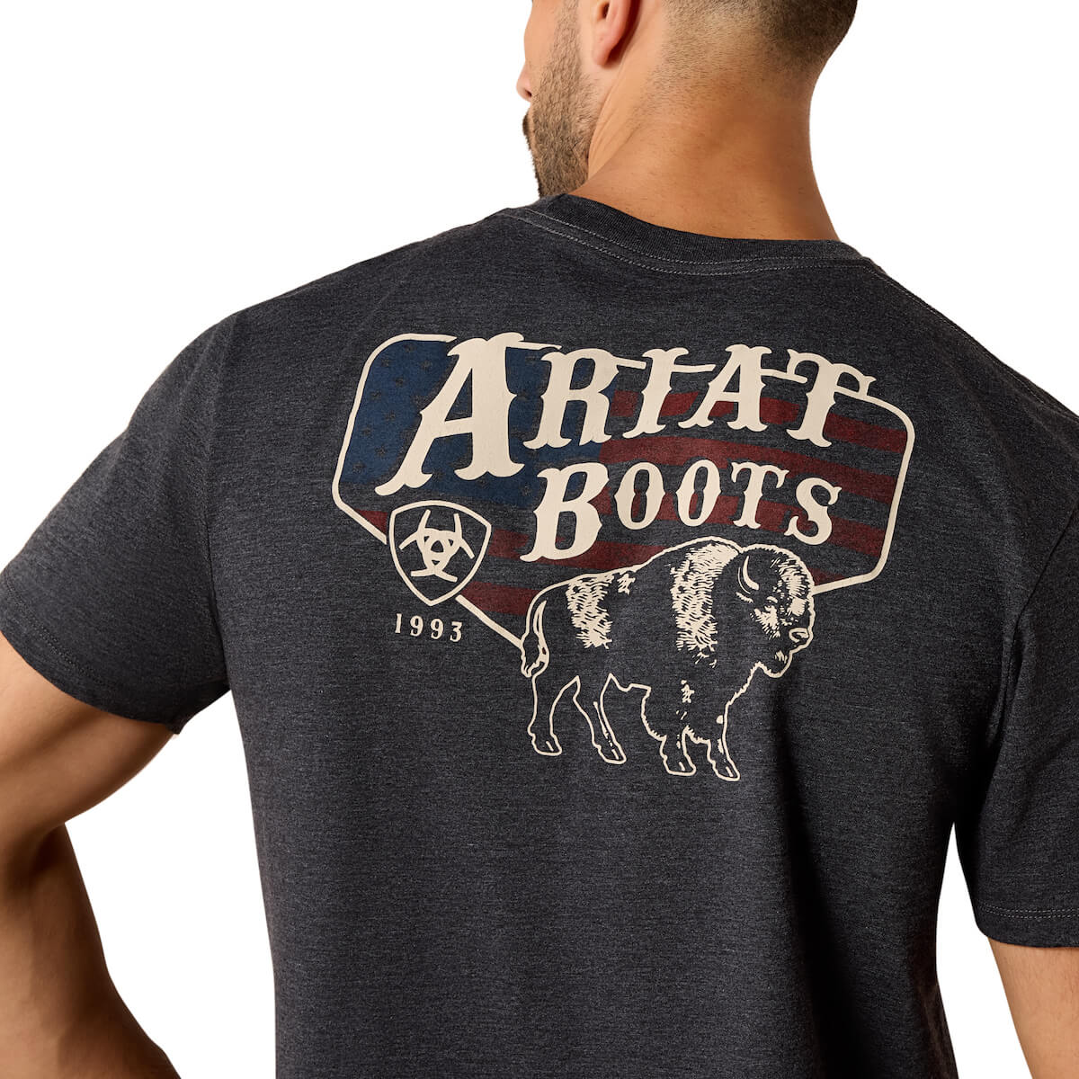 Person wearing a dark gray t-shirt with 'Ariat Boots' logo on the back
