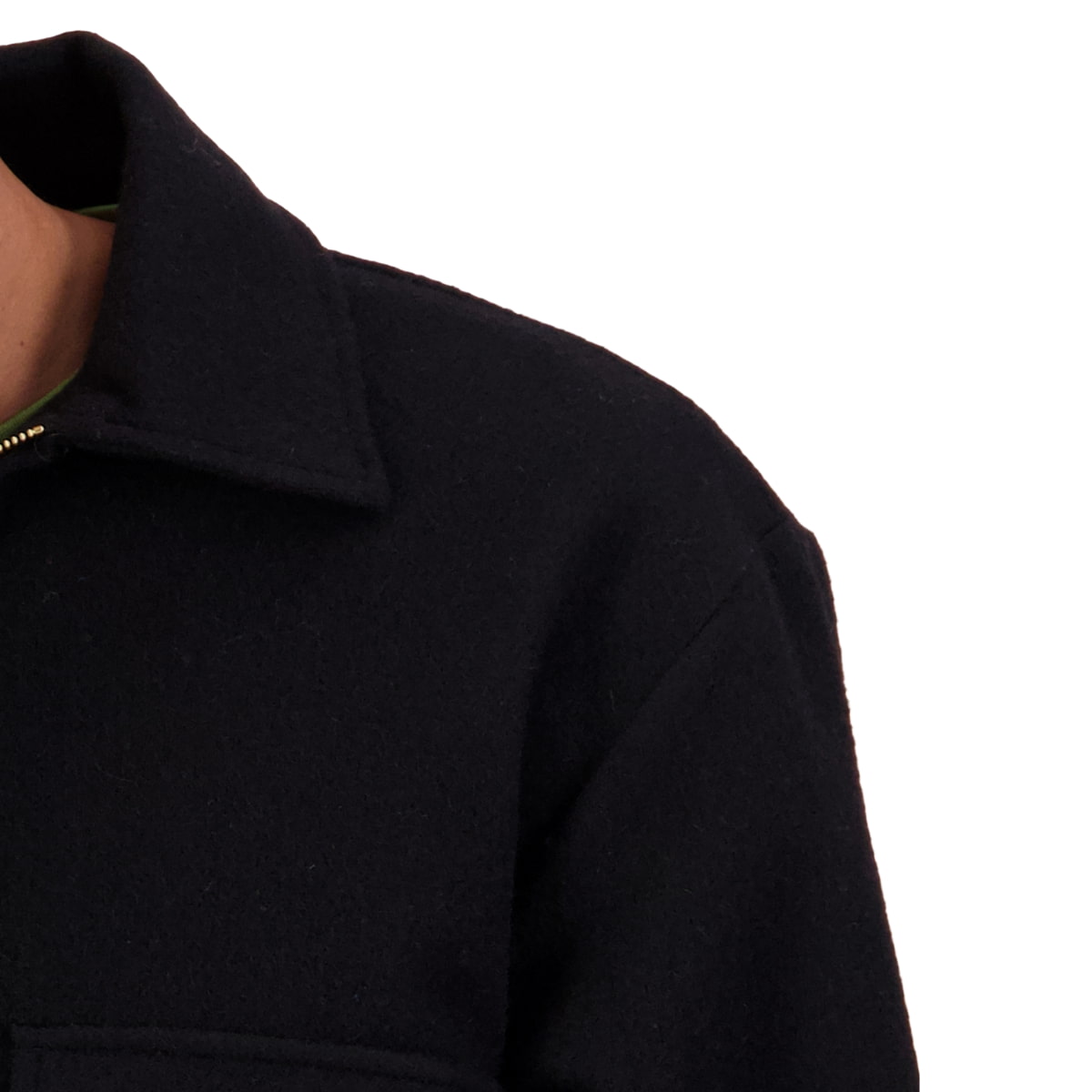 Close-up of a person wearing a dark navy wool-blend jacket, showing the collar, shoulder, and chest area against a plain white background.