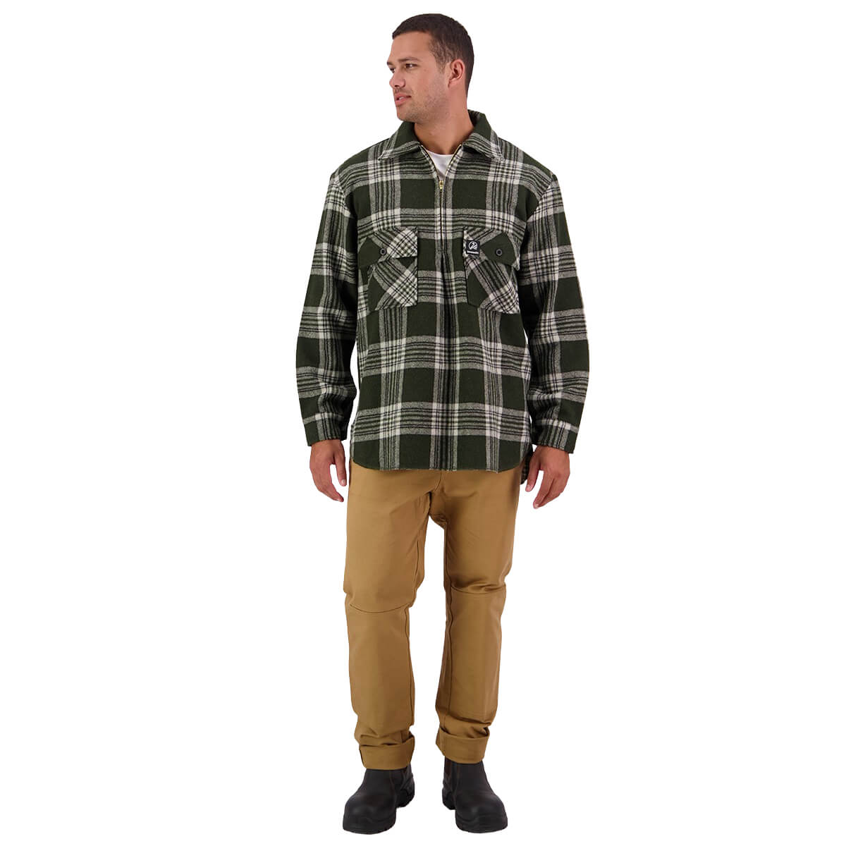 Man wearing a green plaid shirt and beige pants on a white background