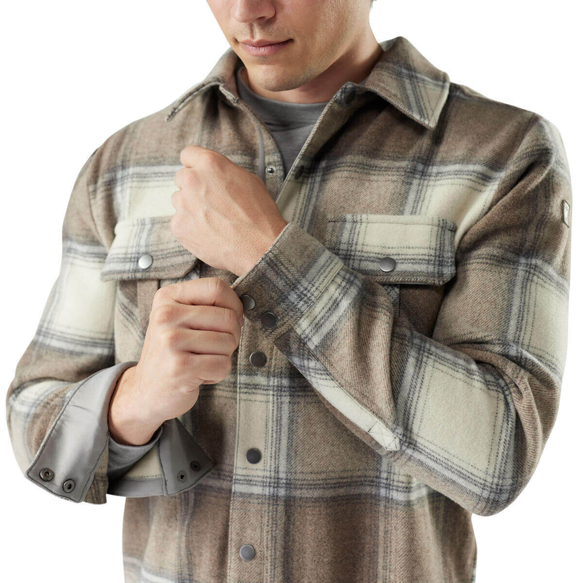 Man wearing a plaid shirt with a neutral color palette on a white background