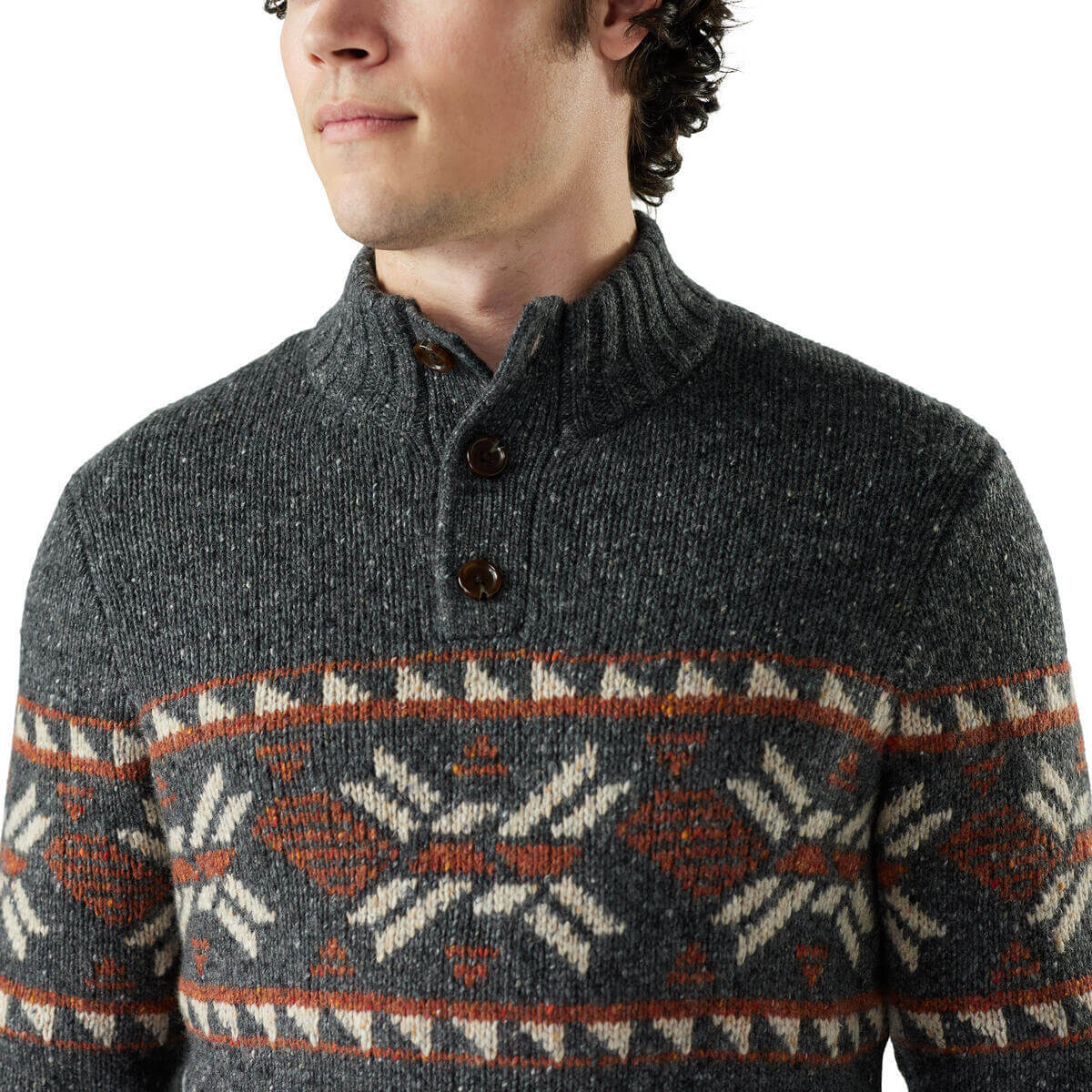 Man wearing a gray sweater with a patterned design on a white background