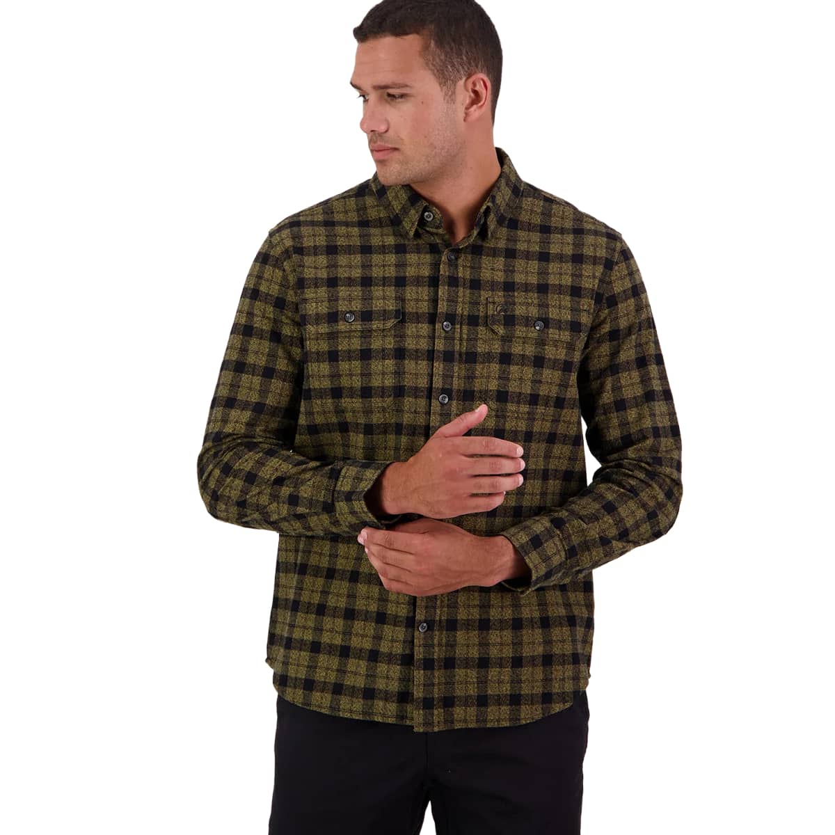 A man wearing a long-sleeve button-down flannel shirt with a dark green and black plaid pattern, paired with black pants, photographed against a solid white background.