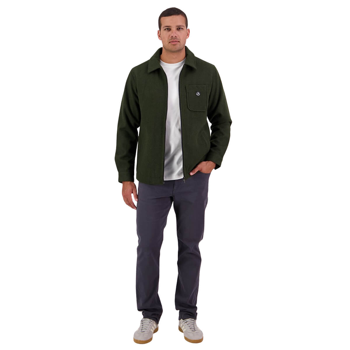 Man wearing a green jacket, white shirt, and dark pants on a white background