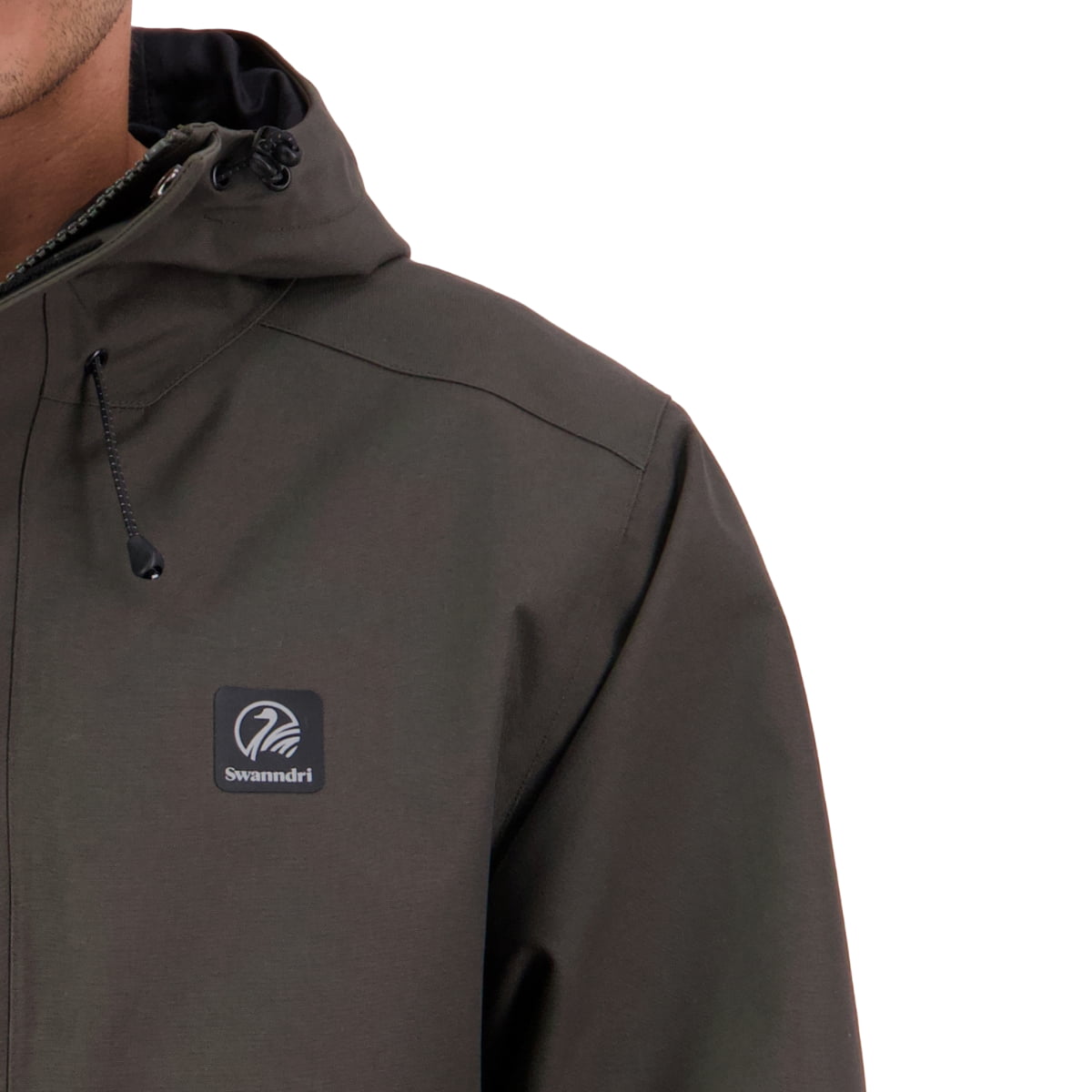 Close-up of a person wearing a dark brown hooded jacket with a black Swimmdri logo patch on the left chest, against a plain white background.