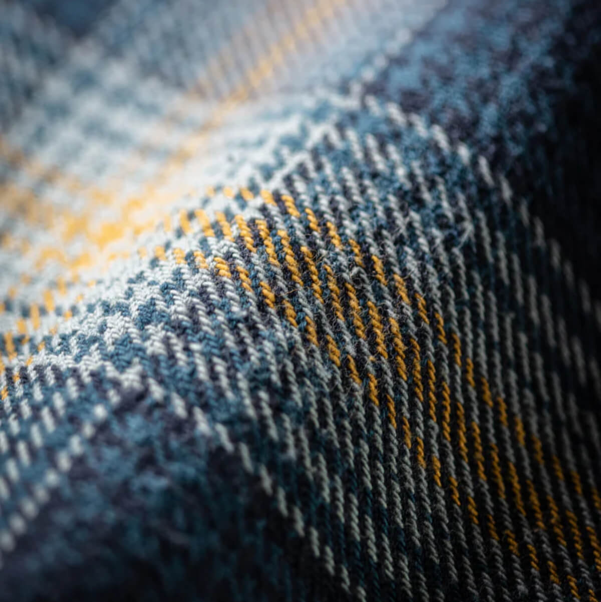 Close-up of a textured fabric with blue and yellow plaid pattern