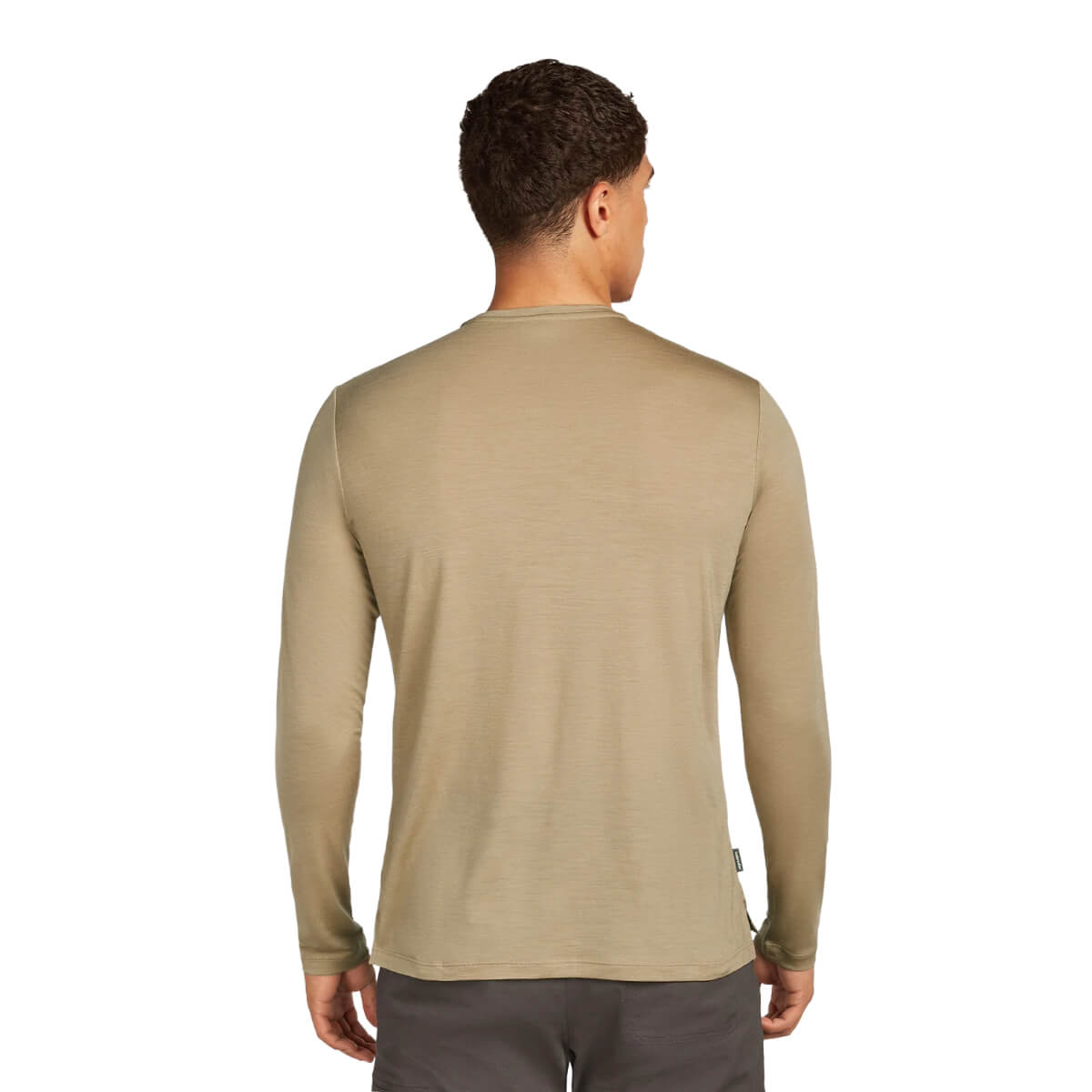 Man wearing a beige long-sleeve shirt on a white background