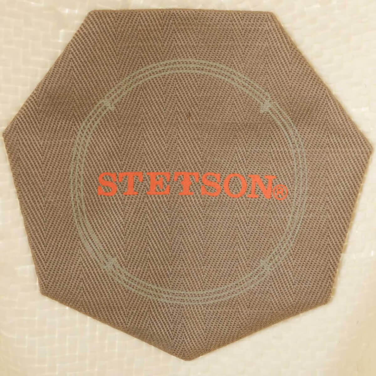Hexagonal mat with 'STETSON' logo on a beige background