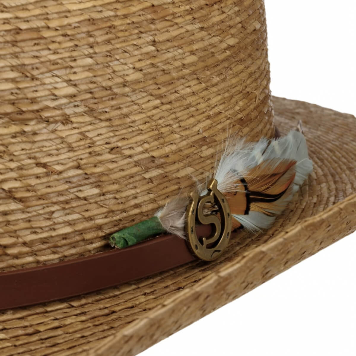 Close-up of a straw hat with decorative elements on a white background