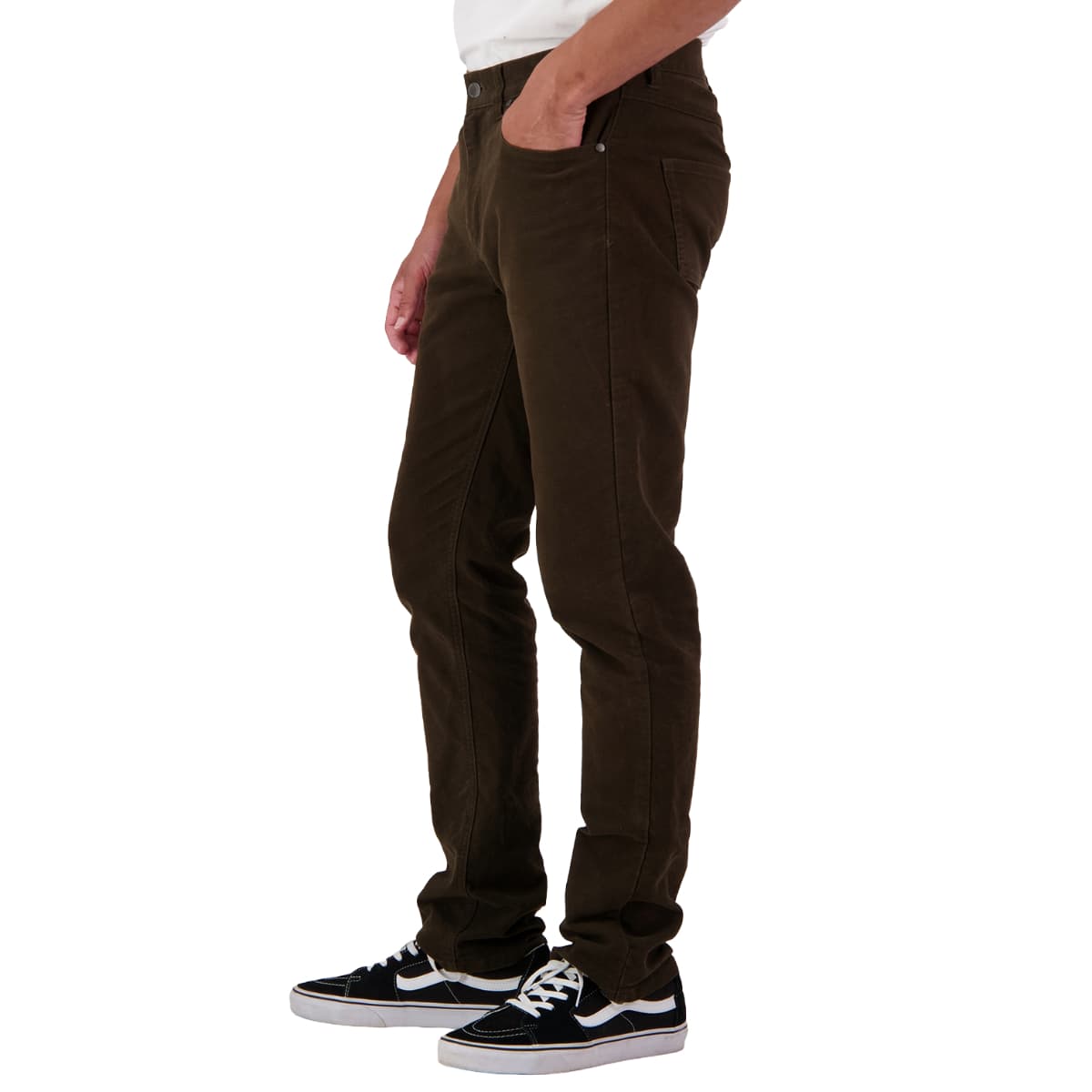 A person shown from the waist down wearing dark brown slim-fit corduroy pants, styled with black and white sneakers against a plain white background.