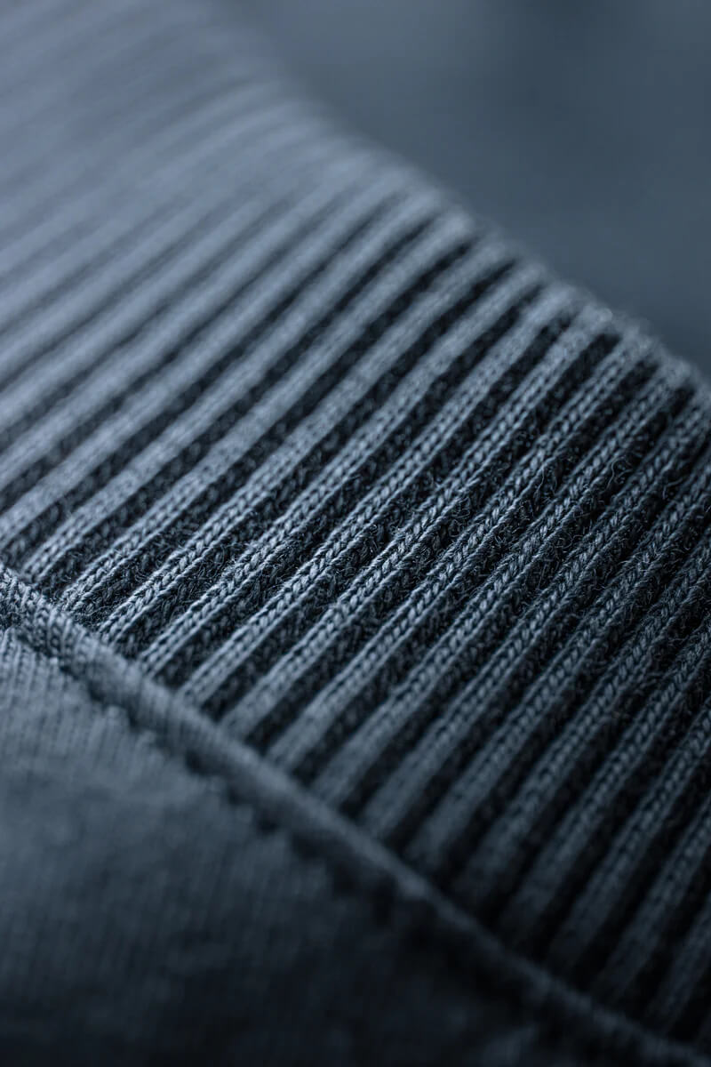 Close-up of a textured fabric with visible stitching details.