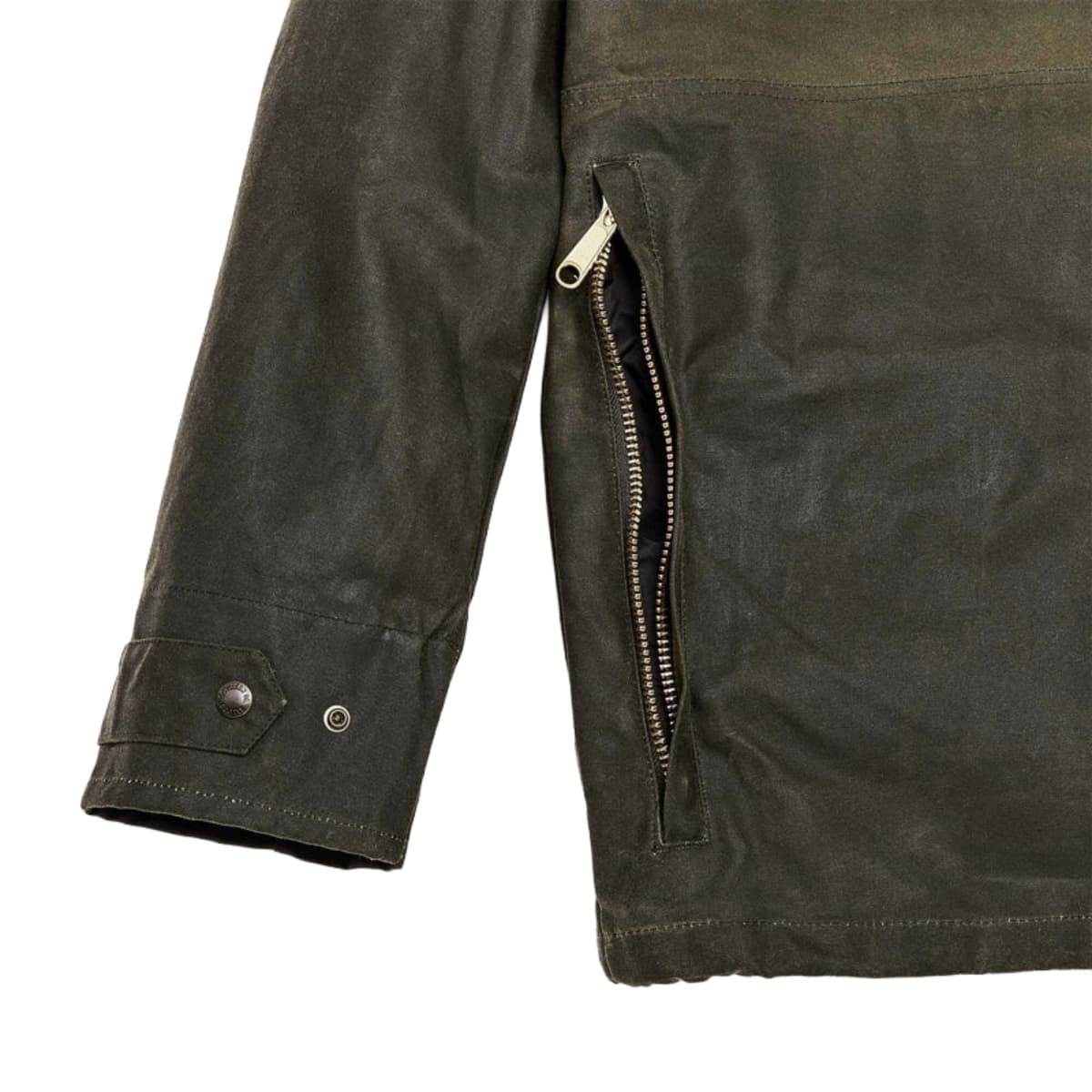 Close-up of a Filson Tin Cloth Field Jacket  showing a side zippered pocket, sleeve cuff with snap buttons, and textured fabric on a white background.
