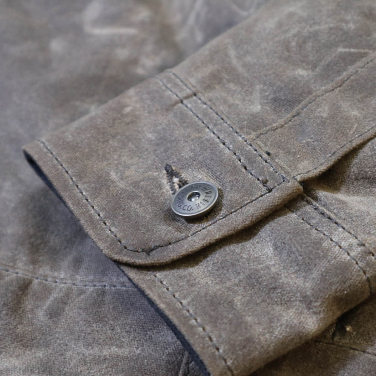 Close-up of a button on a textured fabric surface