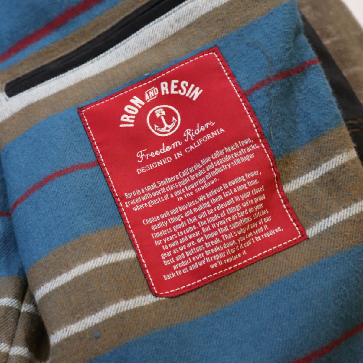 Close-up of a red label on a striped fabric background