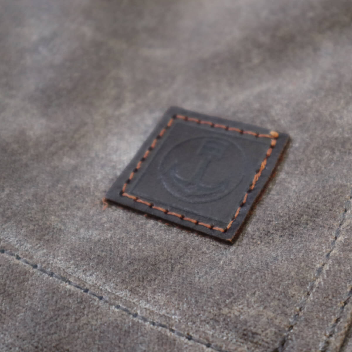 Close-up of a leather label on a textured surface