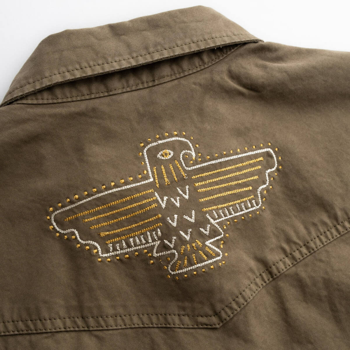 Brown jacket with embroidered eagle design on a white background